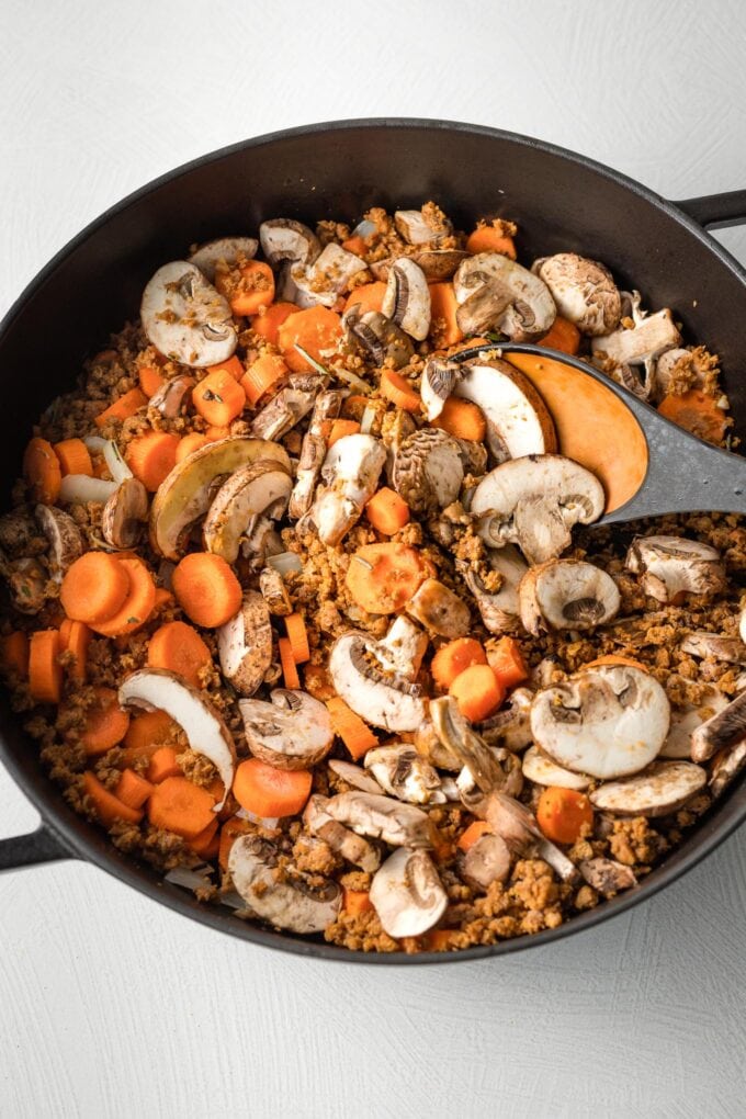 Veggies cooking in a deep skillet.