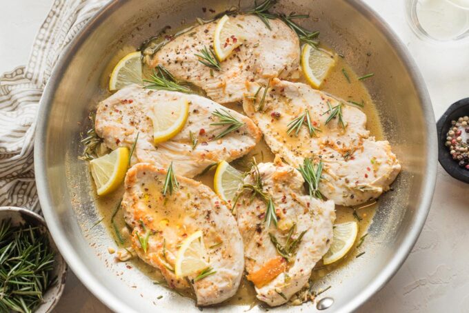 Final step: returning cooked chicken breasts to the pan and warming through with the lemon rosemary pan sauce.