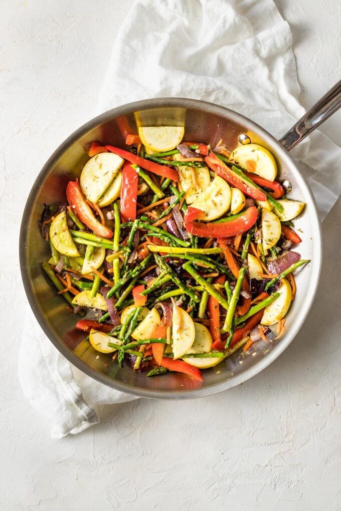 Skillet with squash cooked and garlic and herbs added.