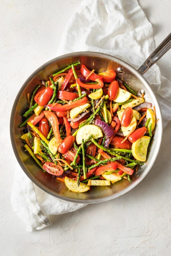 Skillet with cherry tomatoes added.
