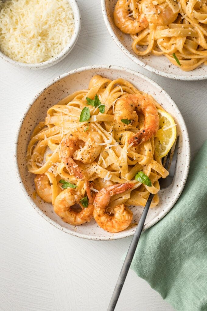 Bowls of blackened shrimp Alfredo, ready to eat.