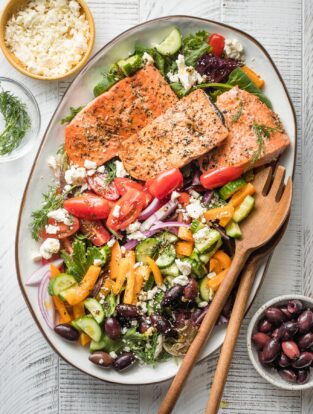 Greek salmon salad served on a white platter.