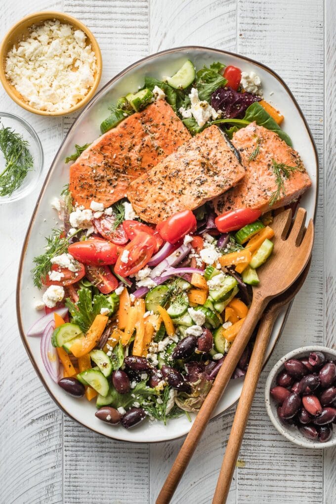 Greek salmon salad served on a white platter.