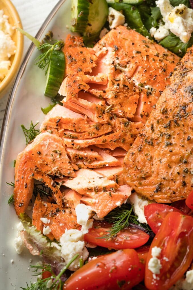 Close-up of flaked salmon filets, with pieces broken off.