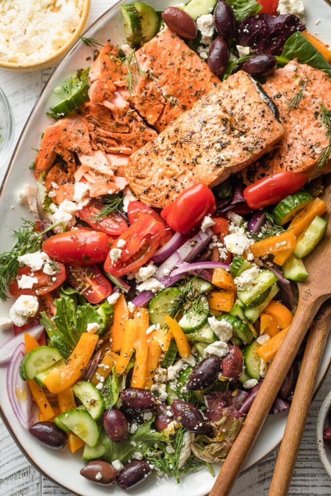 Close-up of Greek salmon salad served on a platter.
