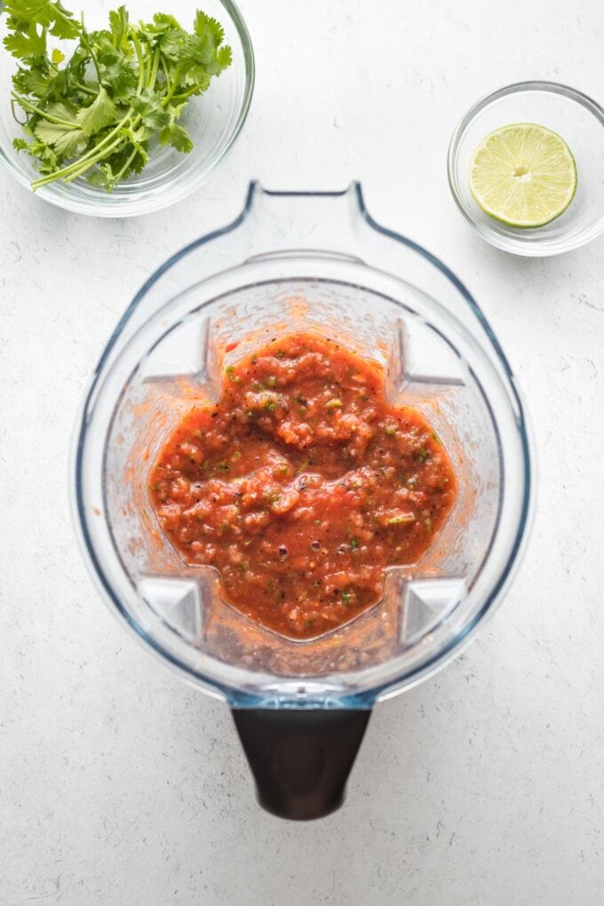 Blender with salsa ingredients, just mixed together.