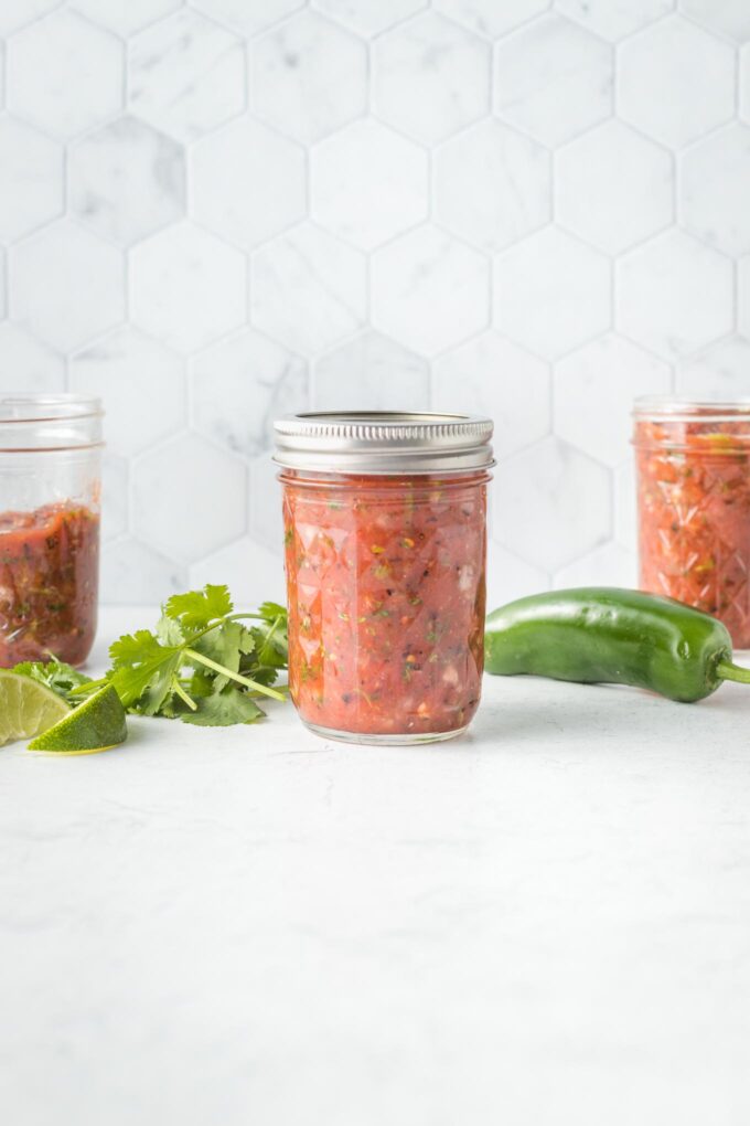 Three jars of blender salsa, ready to store.