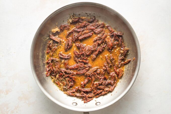Sun-dried tomatoes in skillet.