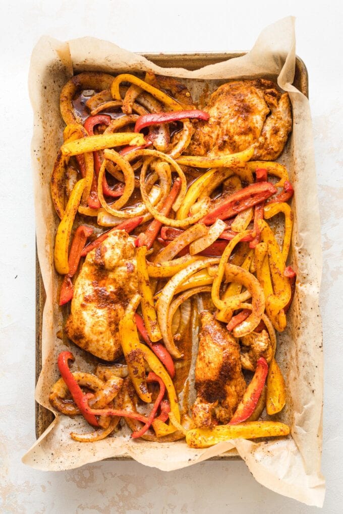 Cooked chicken and veggies still on the sheet pan.