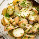 Close-up of herb potato salad in a serving bowl.