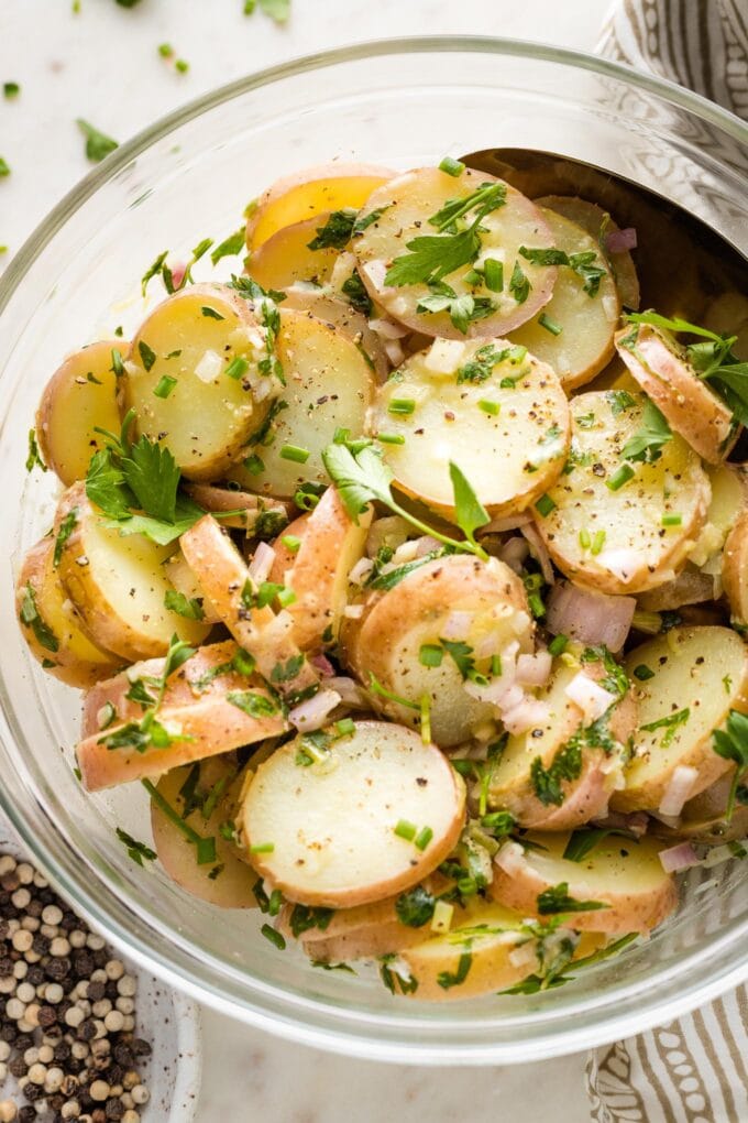 Close-up of herb potato salad in a serving bowl.