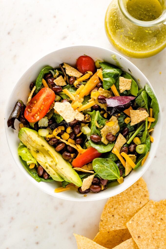 Vegetarian taco salad with black beans tossed together in a bowl, ready to eat.