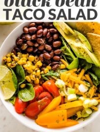 Tacos get a healthy upgrade in the form of a Vegetarian Taco Salad with black beans, a rainbow of veggies, crushed tortilla chips, and a mouth-watering fresh cilantro lime salad dressing.