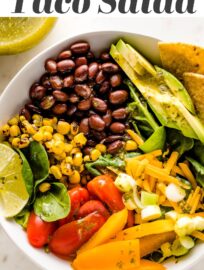 Tacos get a healthy upgrade in the form of a Vegetarian Taco Salad with black beans, a rainbow of veggies, crushed tortilla chips, and a mouth-watering fresh cilantro lime salad dressing.