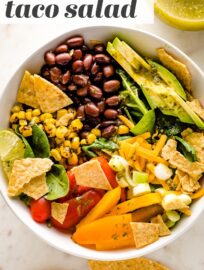 Tacos get a healthy upgrade in the form of a Vegetarian Taco Salad with black beans, a rainbow of veggies, crushed tortilla chips, and a mouth-watering fresh cilantro lime salad dressing.