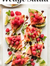 Watermelon Raspberry Mint Wedges: summer on a plate! Slices of crisp watermelon piled high with sweet berries, dusted with zippy mint, lime, and sea salt, then drizzled with tangy balsamic glaze. Serve as an appetizer, snack, or even a salad.