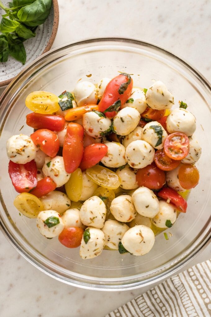 Tomatoes tossed into the olive oil-mozzarella mixture.