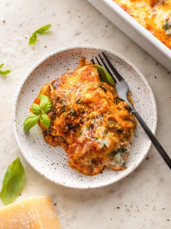 Plate with a heaping portion of baked ravioli.