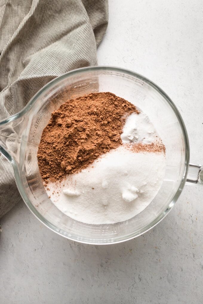 Flour, sugar, and cocoa powder in a clear glass mixing bowl.