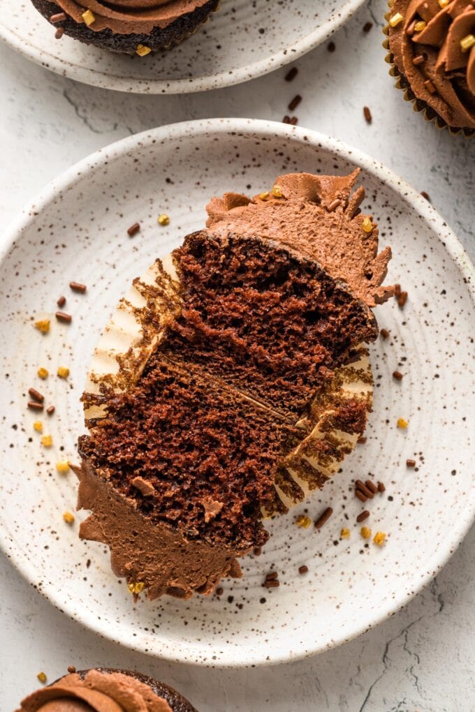 Close-up of a chocolate buttermilk cupcake, split in half to show the moist, chocolately inside.