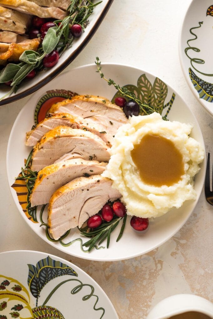 Turkey breast served with mashed potatoes and gravy.