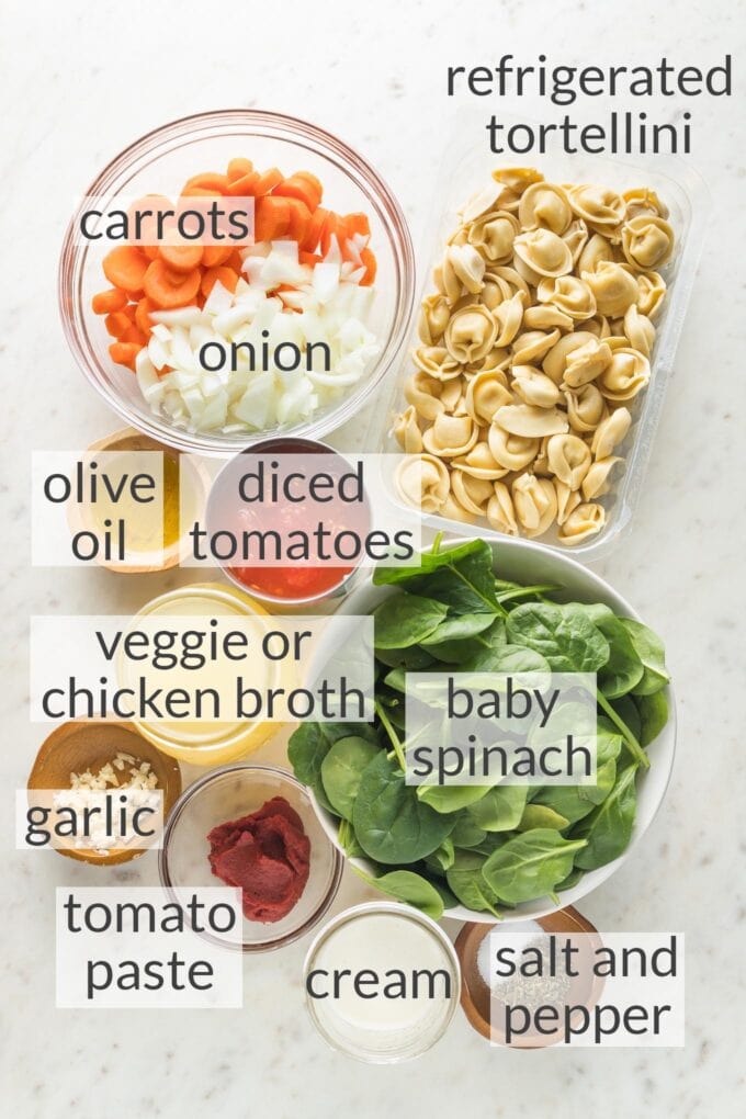 Prep bowls filled with refrigerated tortellini, carrots, onion, olive oil, diced tomatoes, baby spinach, broth, garlic, tomato paste, cream, salt and pepper.