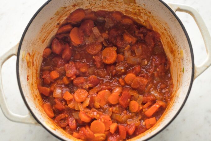 Tomato paste and aromatics added to Dutch oven.