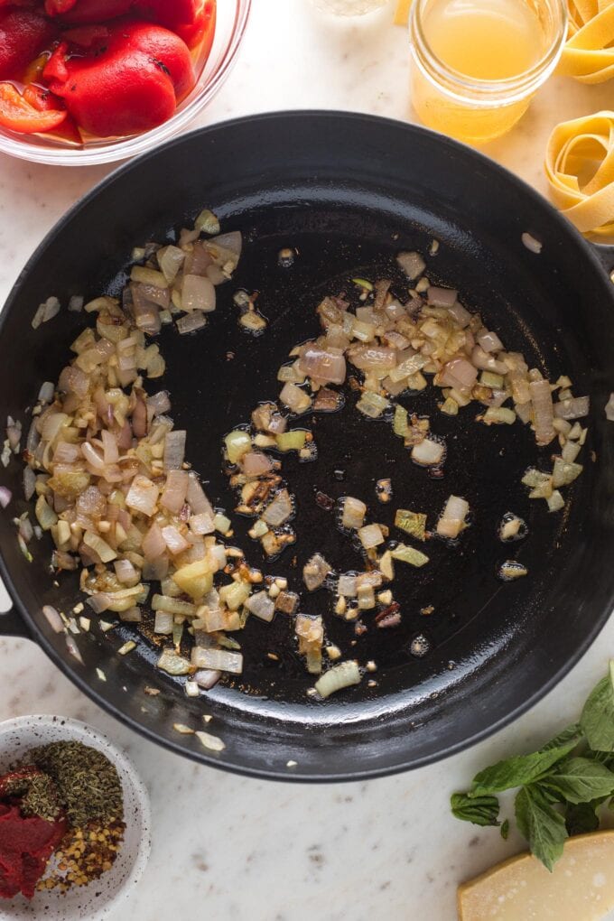 Shallots and garlic cooked in a large skillet.