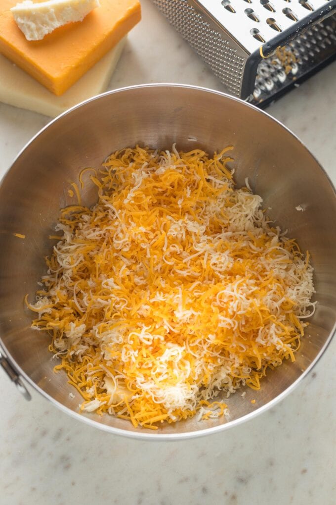 Close up of finely shredded cheddar and Monterey Jack cheese.