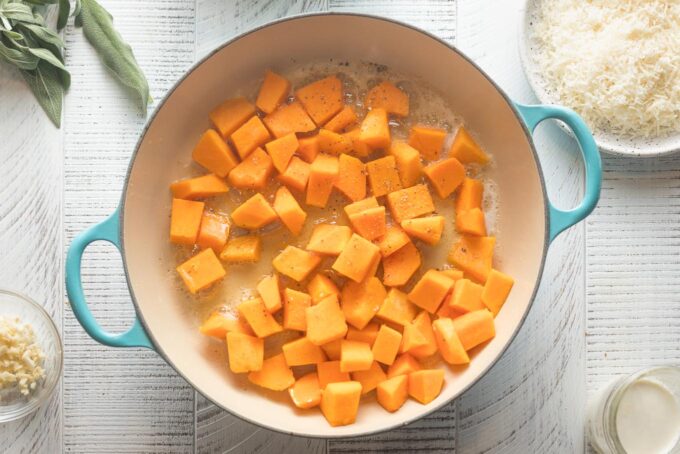 Cubed butternut squash in a skillet ready to cook.