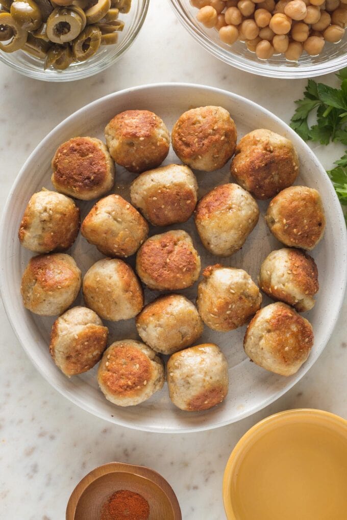 Small plate filled with browned meatballs.