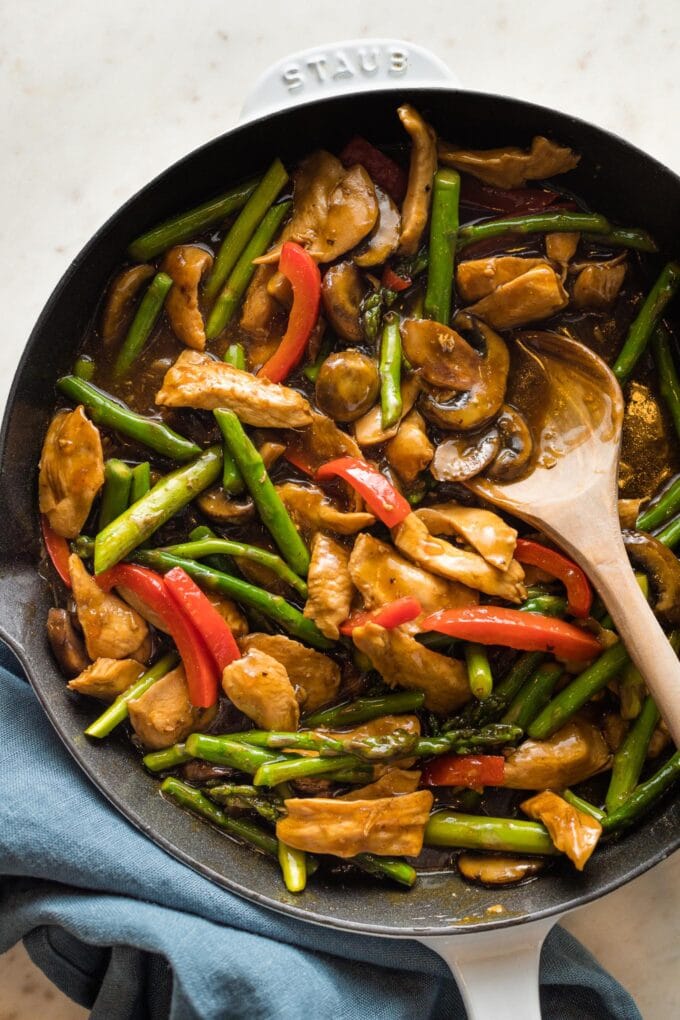 Finished chicken asparagus stir fry in a cast iron skillet.