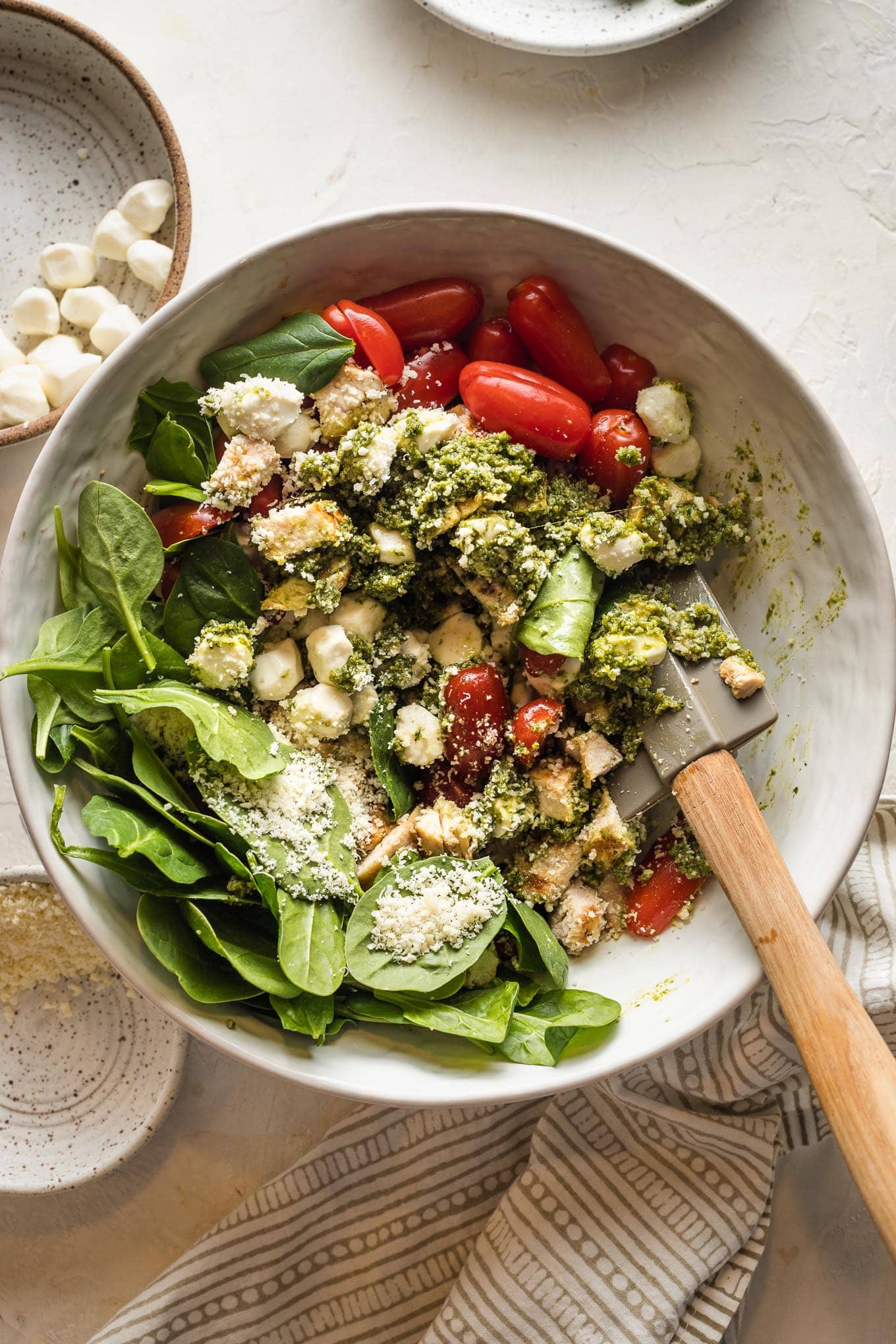 Spinach, mozzarella, and cherry tomatoes added to the pesto mixture.