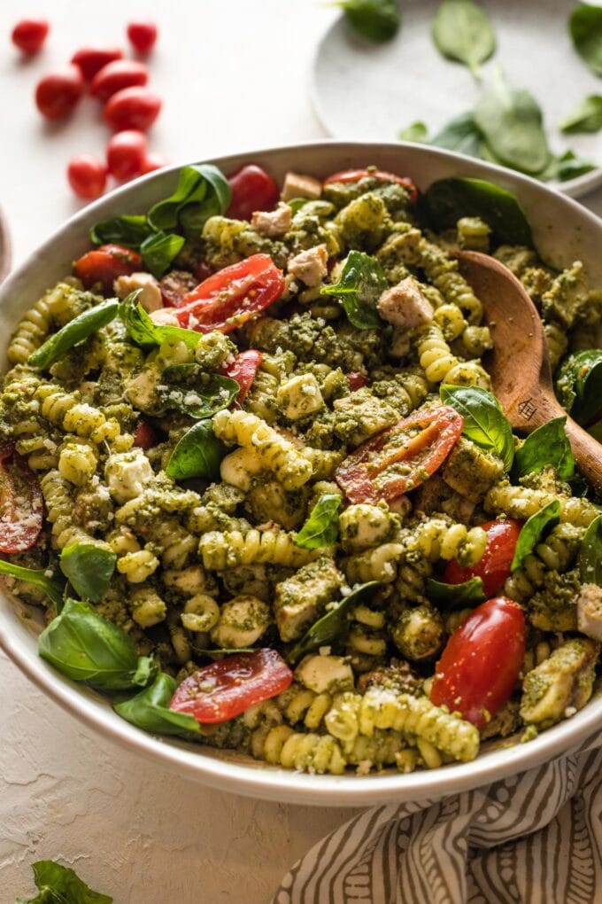 Close up of a chicken pesto pasta salad ready to serve.