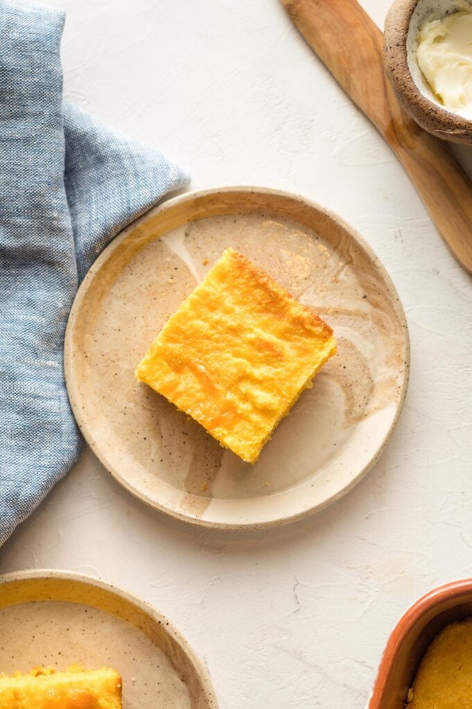 Slice of buttermilk cheddar cornbread served on a small plate.