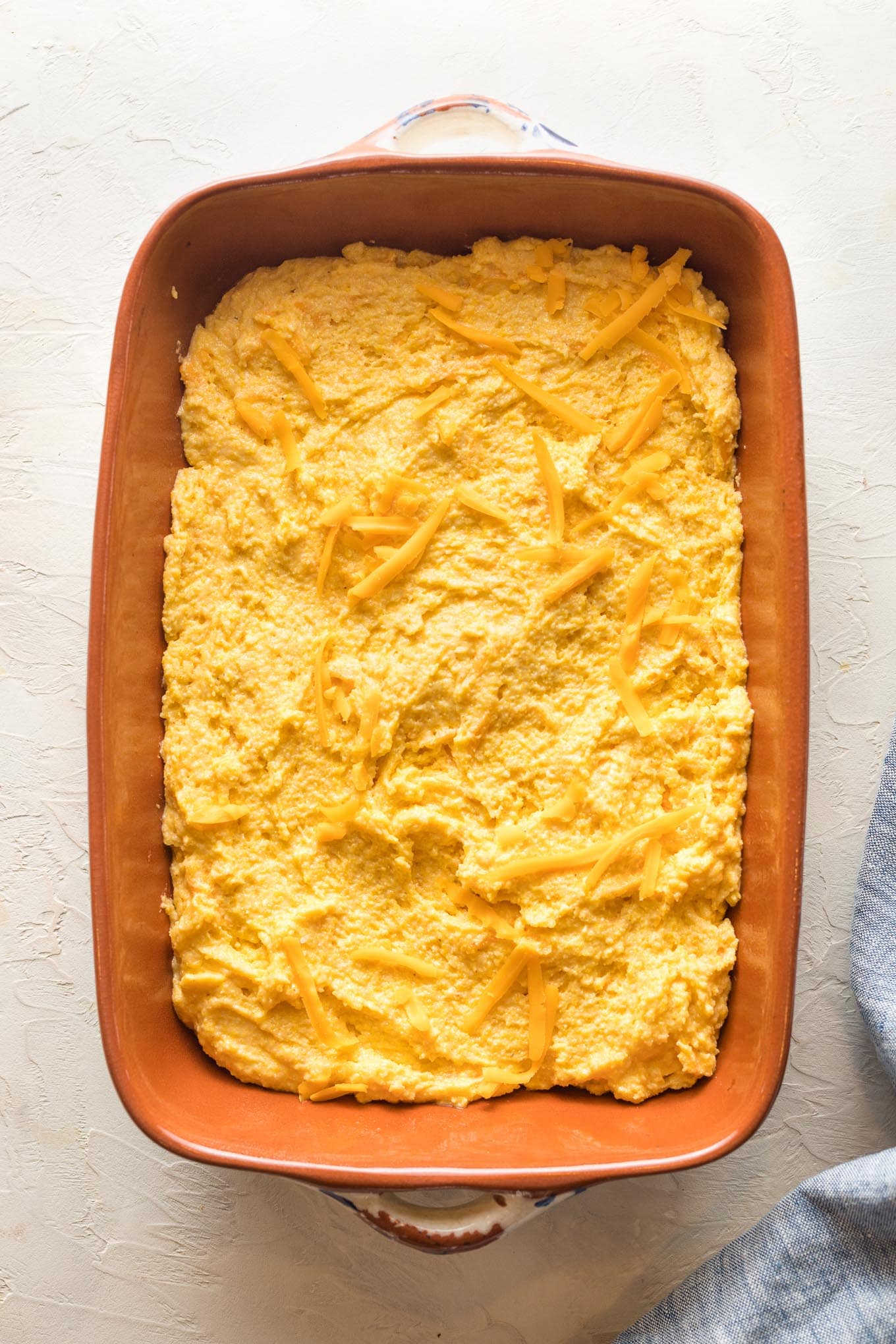 Buttermilk cornbread batter spread into a baking pan.