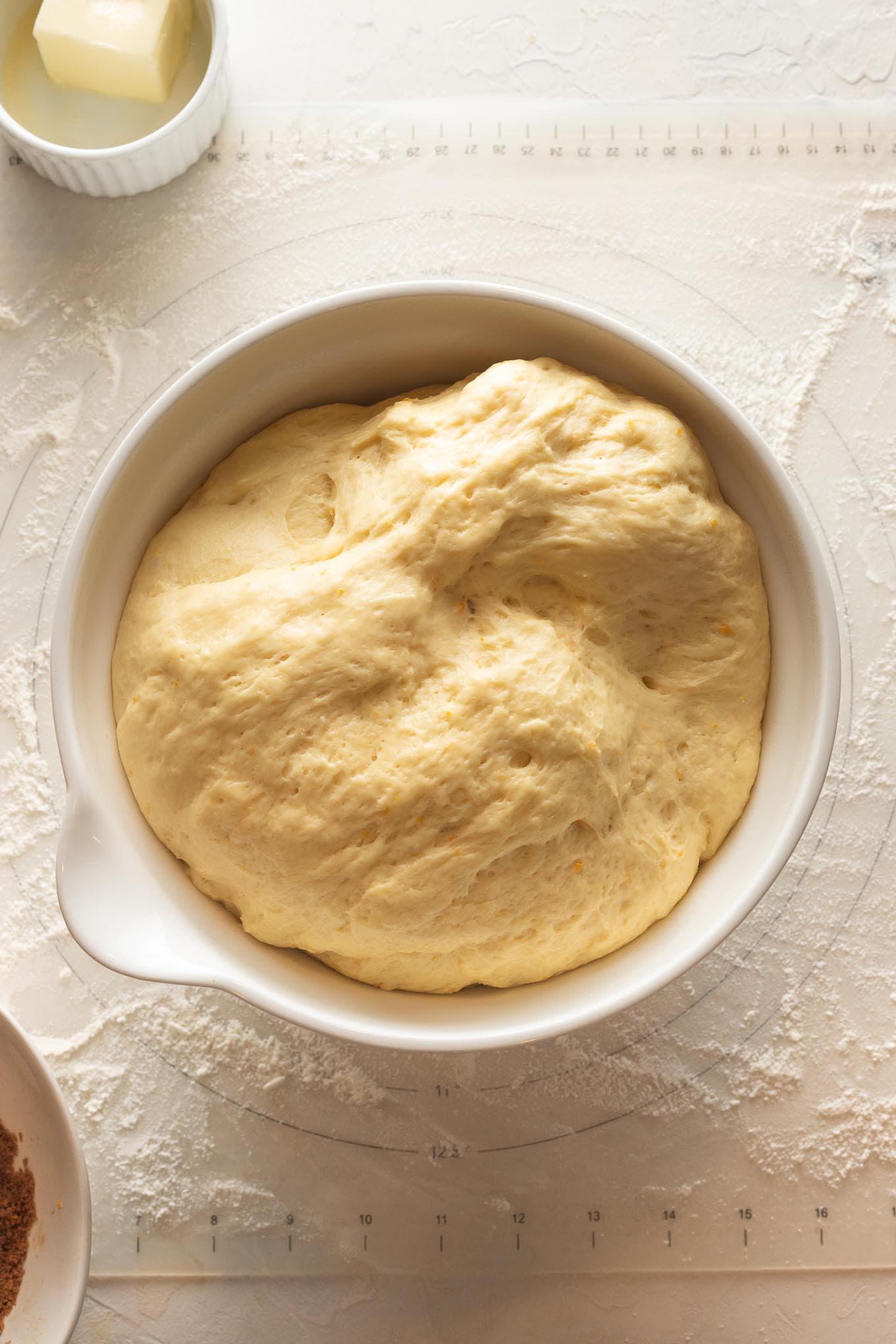Risen dough for homemade orange sweet rolls.