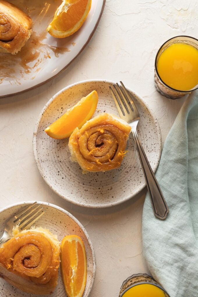 Close up of a homemade glazed orange sweet roll.