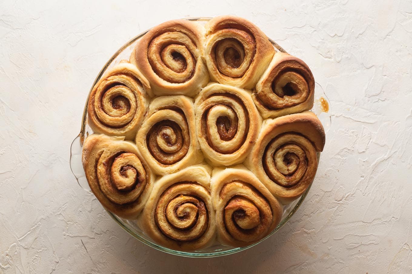 Just-baked orange rolls, browned on top.