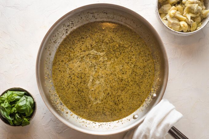 Pesto cream sauce in a skillet.