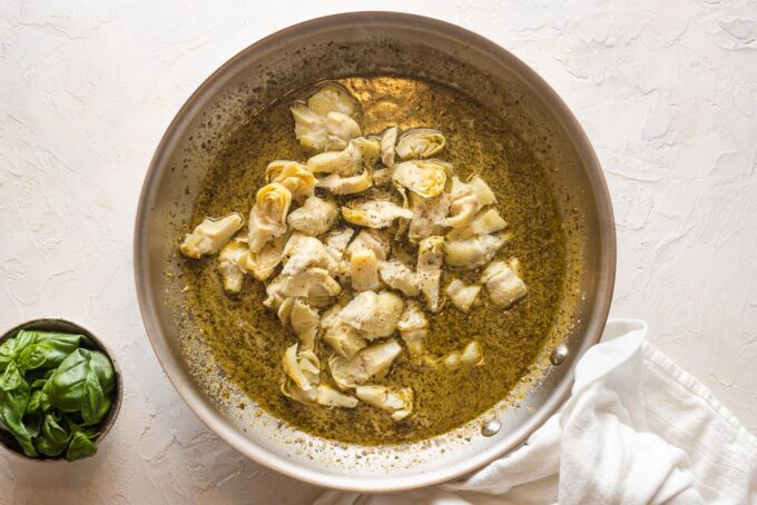 Artichokes added to pesto cream sauce.