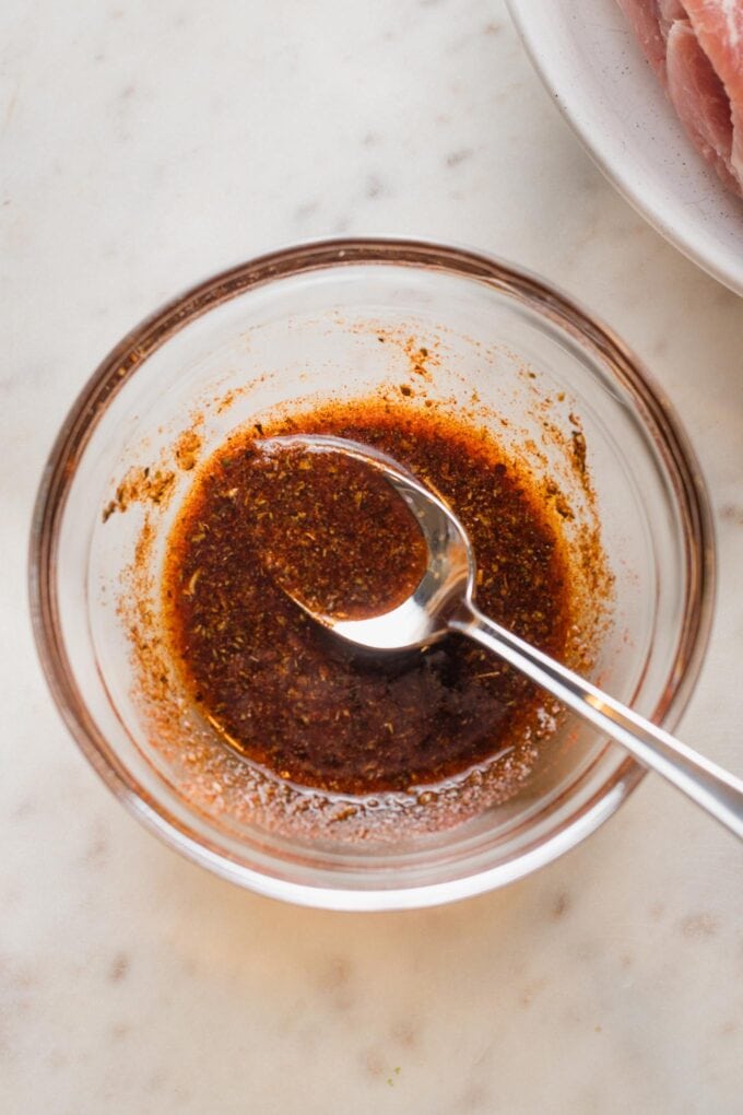 Seasoning blend mixed with olive oil in a small prep bowl.