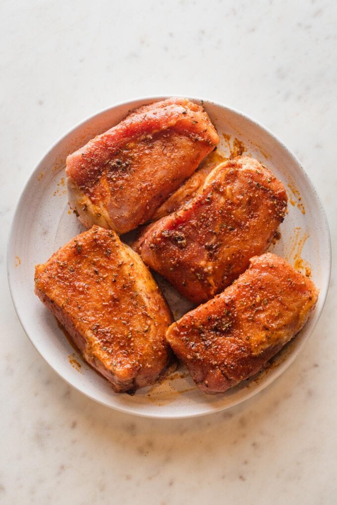 Pork chops rubbed with a vibrant seasoning blend.