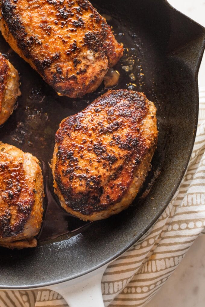 Close-up view of a boneless pork chops seasoned, seared, and baked in the oven.