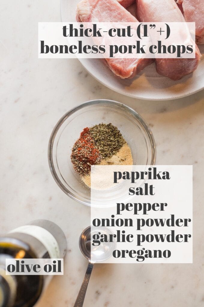 Labeled photo of prep bowls with thick cut boneless pork chops, paprika, salt, pepper, onion and garlic powder, oregano, and olive oil.