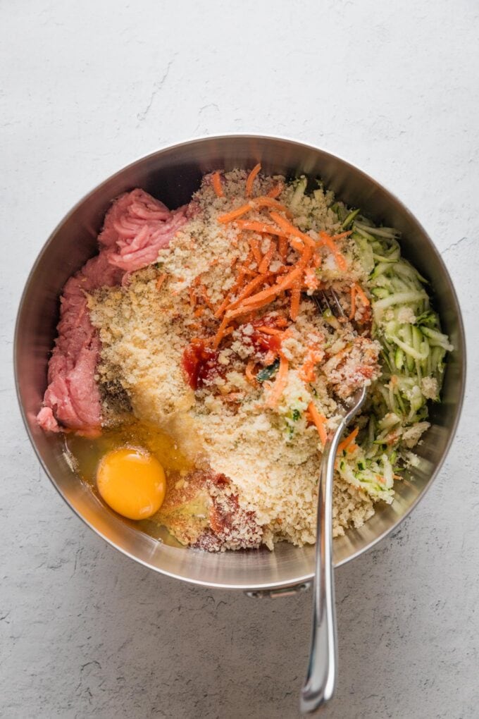 Turkey meatball ingredients combined into a large mixing bowl.