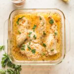 Baked Italian dressing chicken in a square Pyrex baking dish.