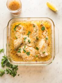 Baked Italian dressing chicken in a square Pyrex baking dish.