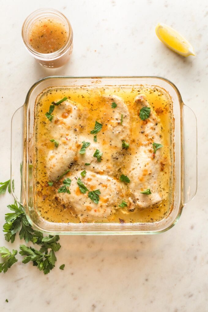 Baked Italian dressing chicken in a square Pyrex baking dish.