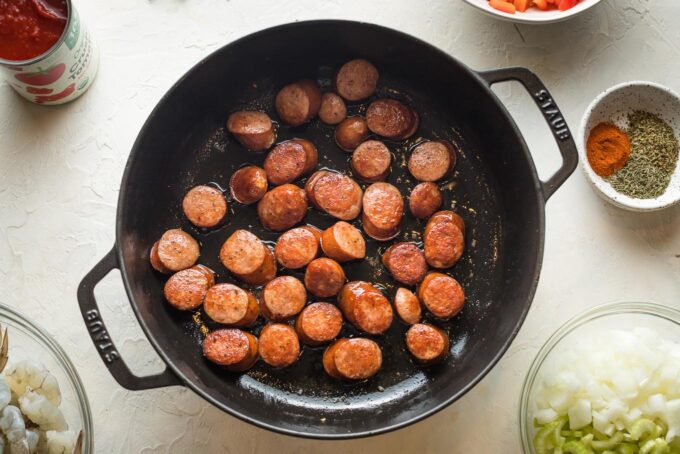 Andouille sausage browned in a pan.
